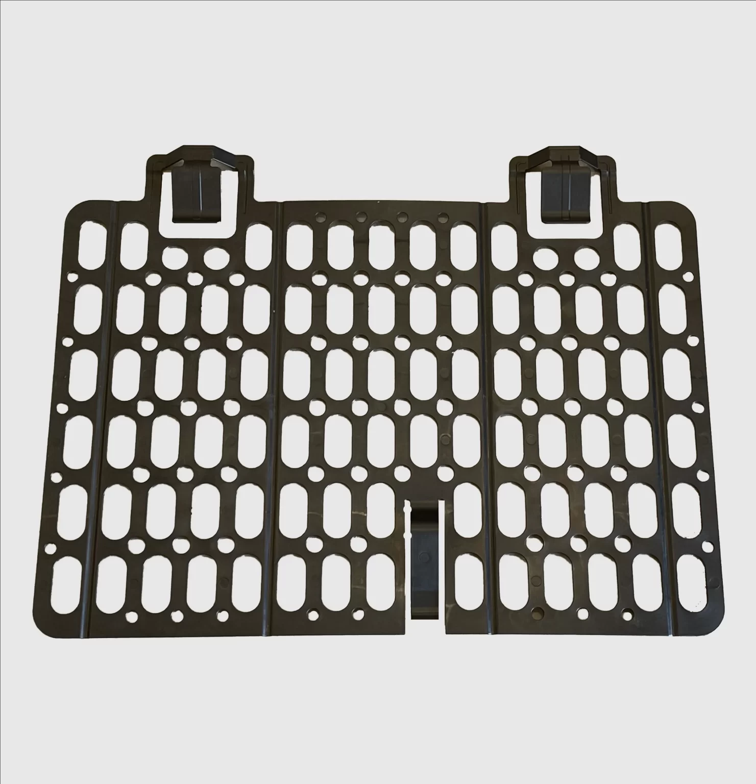 A black scaffolding brick guard mesh with a honeycomb pattern and loops at the top for attachment.